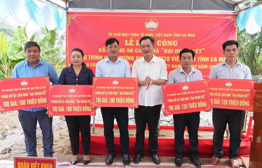 Phó Chủ tịch Ủy ban MTTQ Việt Nam tỉnh Nguyễn Văn Khởi trao bảng tượng trưng cho đại diện các xã được hỗ trợ nhà “Đại đoàn kết”