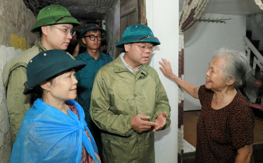 Ông Phạm Hồng Thái, Chủ tịch UBND phường Nam Định khảo sát, vận động người dân di chuyển đến nơi an toàn tránh bão. (Ảnh Thanh Bình)