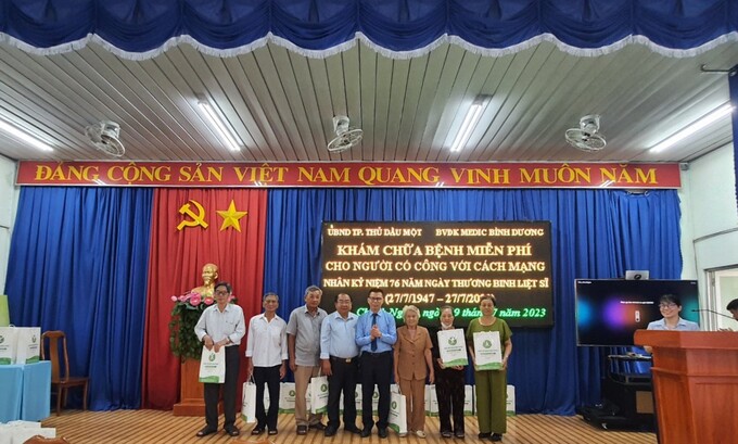 Đại diện Phòng LĐTBXH TP.TDM và Giám Đốc Bệnh viện Medic trao quà cho người có công với cách mạng
