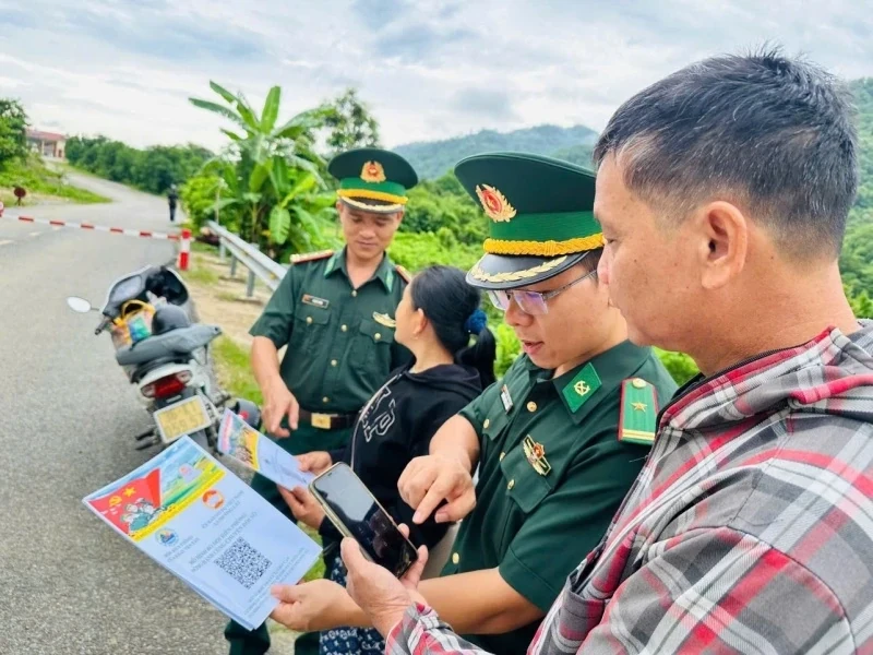 Cán bộ Đồn Biên phòng Cửa khẩu Tén Tằn hướng dẫn người dân quét mã QR, tiếp cận thông tin tuyên truyền trong mô hình “Bộ đội Biên phòng - đồng hành chuyển đổi số nơi biên giới” trên địa bàn xã Mường Lát (Ảnh: Hải Chuyền)
